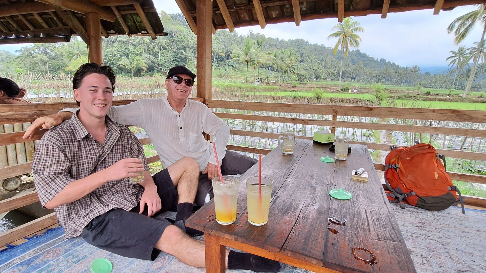 East Java Customised Tours guests relaxing at a rice paddy warung