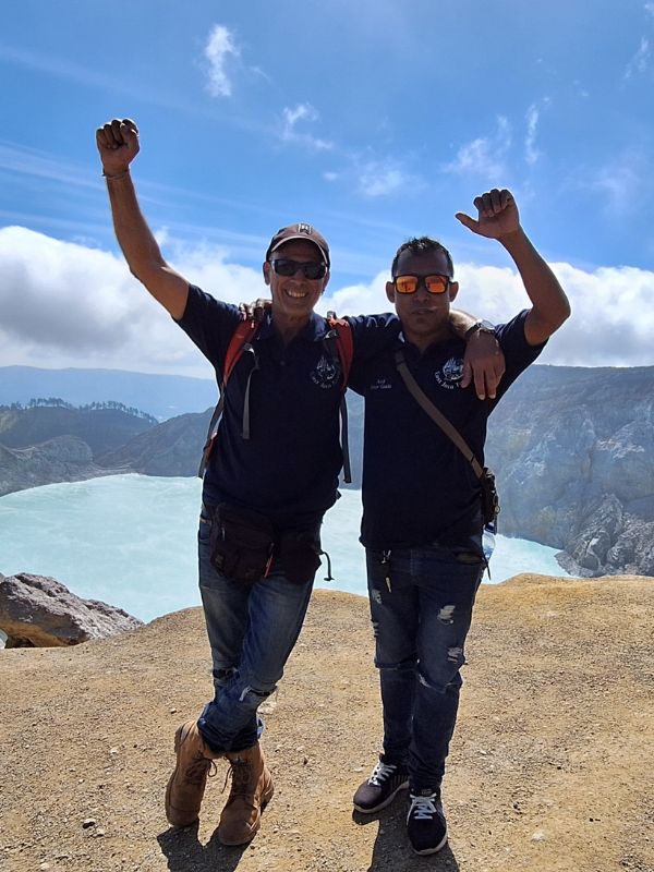 East Java Tours guides Brandon and Andi at Mount Ijen overlooking the blue crater lake