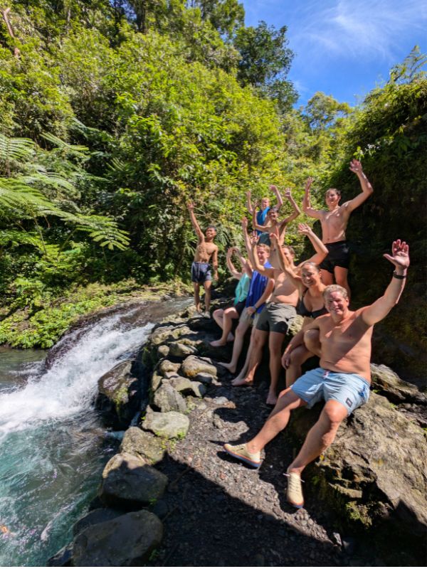 Family enjoying a waterfall with Private East Java Tours